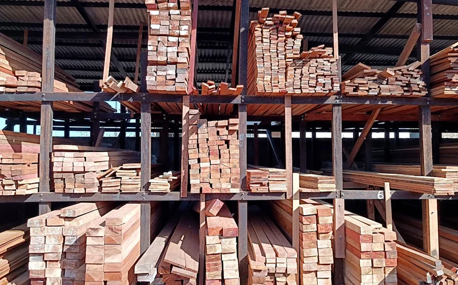 Racking stacked with cut timber and lengths of lumber in a builders merchant’s warehouse