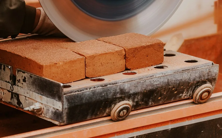 Freshly pressed clay bricks moving along a production line at a building materials factory