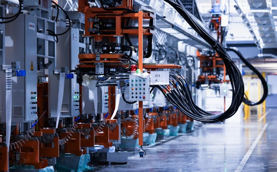 Automated assembly line with cabling and control gear at an electrical components factory